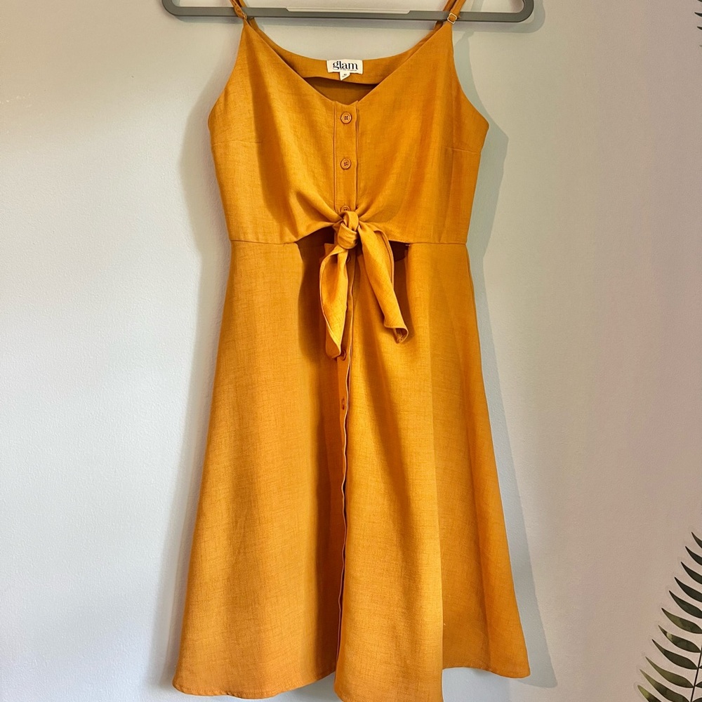 Mustard gold cut-out waist midi length dress.
